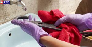 Rinsing eye hook and cleaning it under running water and wiping it dry